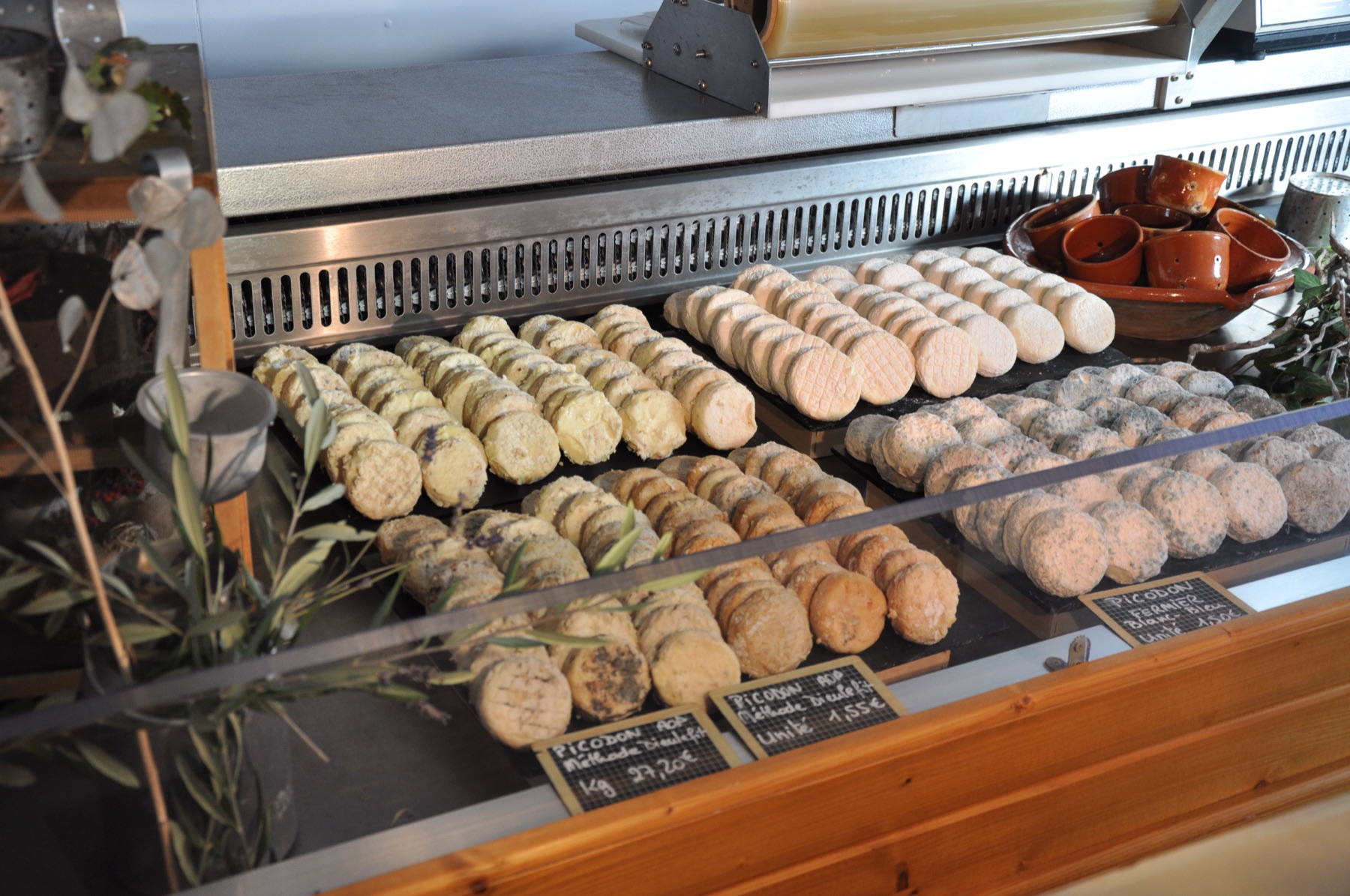 Plateaux de picodons crème, orangés et cendrés vus en plongée